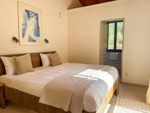 a bedroom with a large bed in a room at Villa Thea with Pool & panoramic Sea View in Kotrónion +26 photos