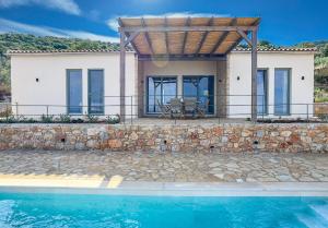 a villa with a swimming pool and a house at Villa Thea with Pool & panoramic Sea View in Kotrónion