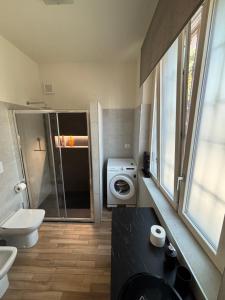 a bathroom with a toilet sink and a washing machine at Residenza Vignoli Seregno Centro in Seregno +14 photos