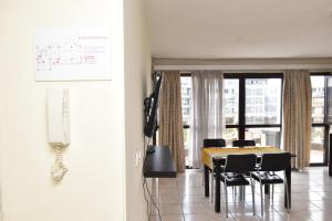 a dining room with a table and chairs at Residency by LMR in Kigali +21 photos