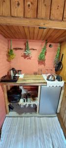 a kitchen with a counter with pots and pans at Little Red Sauna by the Sea in Leesi