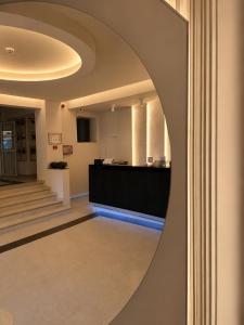 a hallway with a round mirror on the wall at Hotel Gala in Cluj-Napoca