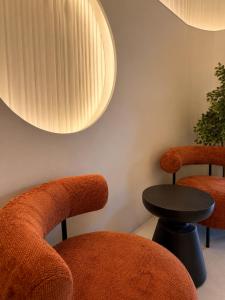 a room with two chairs and a table and a light at Hotel Gala in Cluj-Napoca