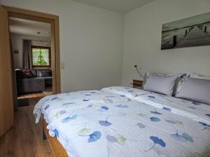 a bedroom with a bed with a blue comforter at Ferienwohnung Habit in Tschagguns