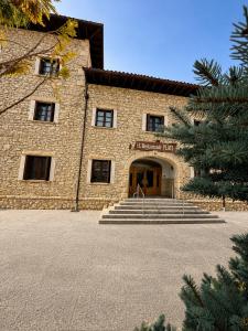 a large stone building with stairs in front of it at Hotel Restaurante Plati in Villarcayo