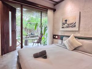 a bedroom with a large bed and a large window at CasaWa Homestay Hue in Thôn Trường Giang