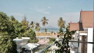 a view of the beach from the balcony of a resort at Hila Hotel Vạn Ninh in Vạn Ninh