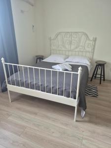 a bedroom with a bed with a white bed frame at Tom House in Otopenii de Jos