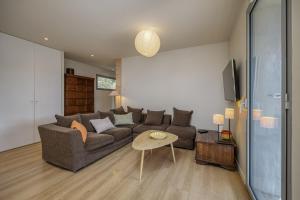 a living room with a couch and a table at Wooden Villa 4 in Veyrier-du-Lac