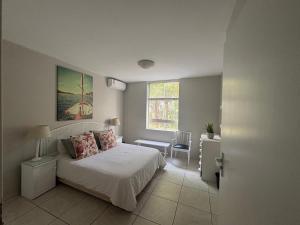 a bedroom with a bed and a window at 18 Ipanema Beach in Durban +14 photos
