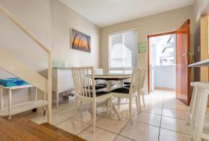 a dining room with a table and chairs at 18 Ipanema Beach in Durban