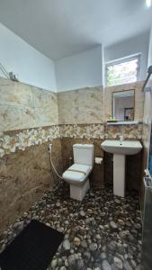 a bathroom with a toilet and a sink at NATIVE SOULS Beach Hotel in Induruwa +28 photos