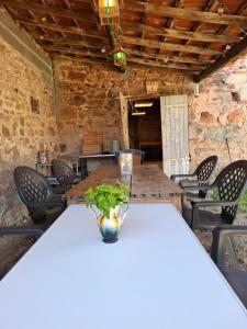 a table with a vase on top of it at La colline de Tara in Andelaroche