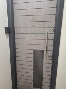 a metal door with the number on it at Tom House in Otopenii de Jos +2 photos