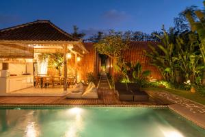 a swimming pool in the backyard of a house at Omaneil Villa in Uluwatu
