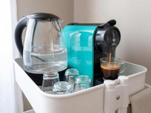 a coffee maker and glasses of water and a coffee pot at Capozucca Home in Città della Pieve