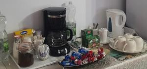 a counter with a coffee maker and other items on it at Casa Tim in Tulcea