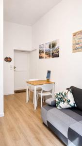 a living room with a table and a couch at Escapade Provencale in Lectoure
