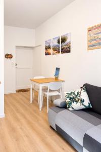 a living room with a table and a couch at Escapade Provencale in Lectoure
