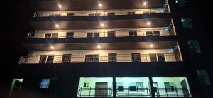 an apartment building at night with its lights on at TEE Guest House in Monrovia