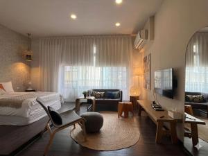 a bedroom with a bed and a living room at Ho.Me-Easyhouse in Tainan +33 photos