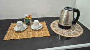 a coffee maker sitting on top of a table at NATIVE SOULS Beach Hotel in Induruwa