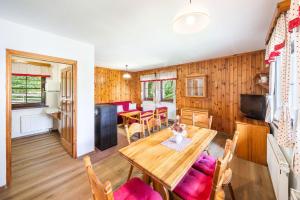 a kitchen and dining room with a wooden table and chairs at Chalupy Na Rališce in Horní Bečva
