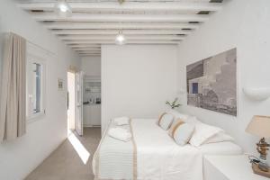 a white room with a white couch in it at Windmill Bella Vista in Artemonas
