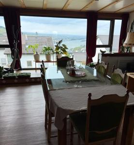 a dining room with a table and a large window at Sunrise Loft in Bingen am Rhein +17 photos