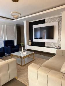 a living room with a couch and a tv at MAI instahomes in Lilongwe +10 photos