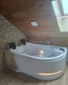 a white bath tub in a room with a ceiling at Charme Suite - Antre-parenthèse in Gravelines +7 photos