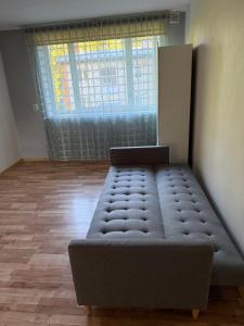 a bed sitting in a room with a window at 40m2 apartmnet in Viljandi +1 photo