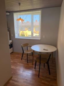 a dining room with a table and chairs and a window at 40m2 apartmnet in Viljandi