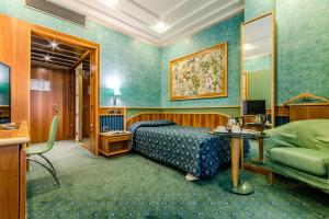 a hotel room with a bed and a couch at Brunelleschi Hotel in Milan +34 photos