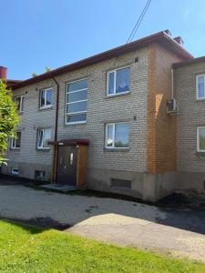 a brick house with a door and a driveway at 40m2 apartmnet in Viljandi
