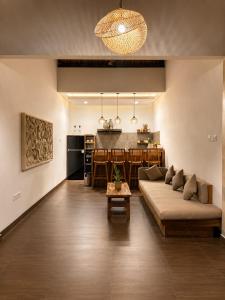 a living room with a couch and a kitchen at Ardinia Villa Ubud Private Pool in Ubud