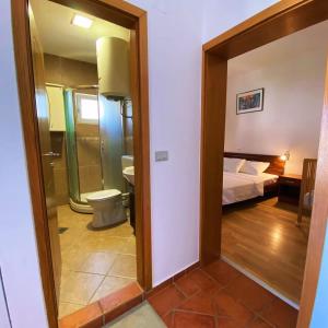 a mirror in a room with a bed and a bathroom at Apartments Bloom Bečići in Bečići +23 photos