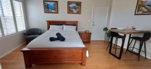 a bedroom with a bed with a pair of shoes on it at Cosy Haven - Large Comfy Dwelling in Mandurah
