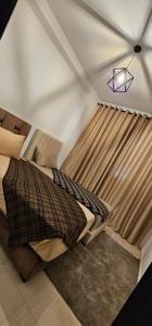 a bedroom with a bed and a light on the ceiling at Very comfortable apartment in Hajreien