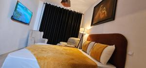 a bedroom with a bed and a tv on the wall at Very comfortable apartment in Hajreien