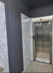 a bathroom with a walk in shower with a door at Comforts apartment 3 in Fnidek