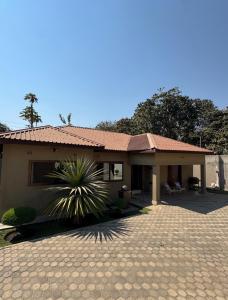 a small house with a tile roof and a patio at JAYNIEL Apartments in Lusaka