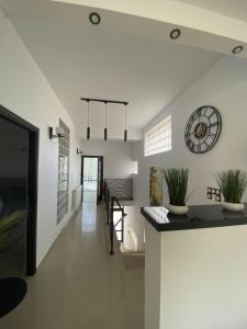 a hallway of a house with a clock on the wall at Apartament Debres Concept in Aiud