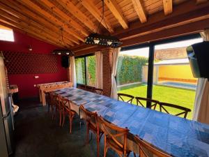 a dining room with a long table and chairs at La Villa de Pi in Garcillán