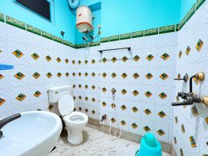 a bathroom with a toilet and a sink at The Binapani Hotel And Restaurant in Tarapith