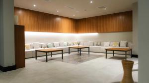a waiting room with a couch and two tables at Palmera Resort Wellness & Spa - Mountain & Pool View Studio 1 by Azur Prime in Vasilia +28 photos