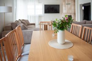 a vase of flowers on a table in a living room at Bieślin 41 in Bieślin
