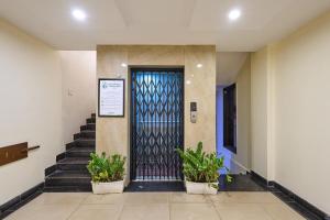 a door in a building with potted plants at Treebo Landmark in Visakhapatnam