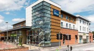 a building on the corner of a street at Travelodge Egham in Egham +9 photos