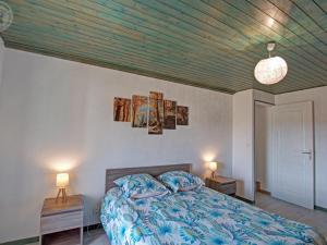 a bedroom with a bed and two lamps and a ceiling at Gîte Les Hortensias à Pralong - Charme et Confort pour 4 Pers avec Internet - FR-1-496-117 in Pralong